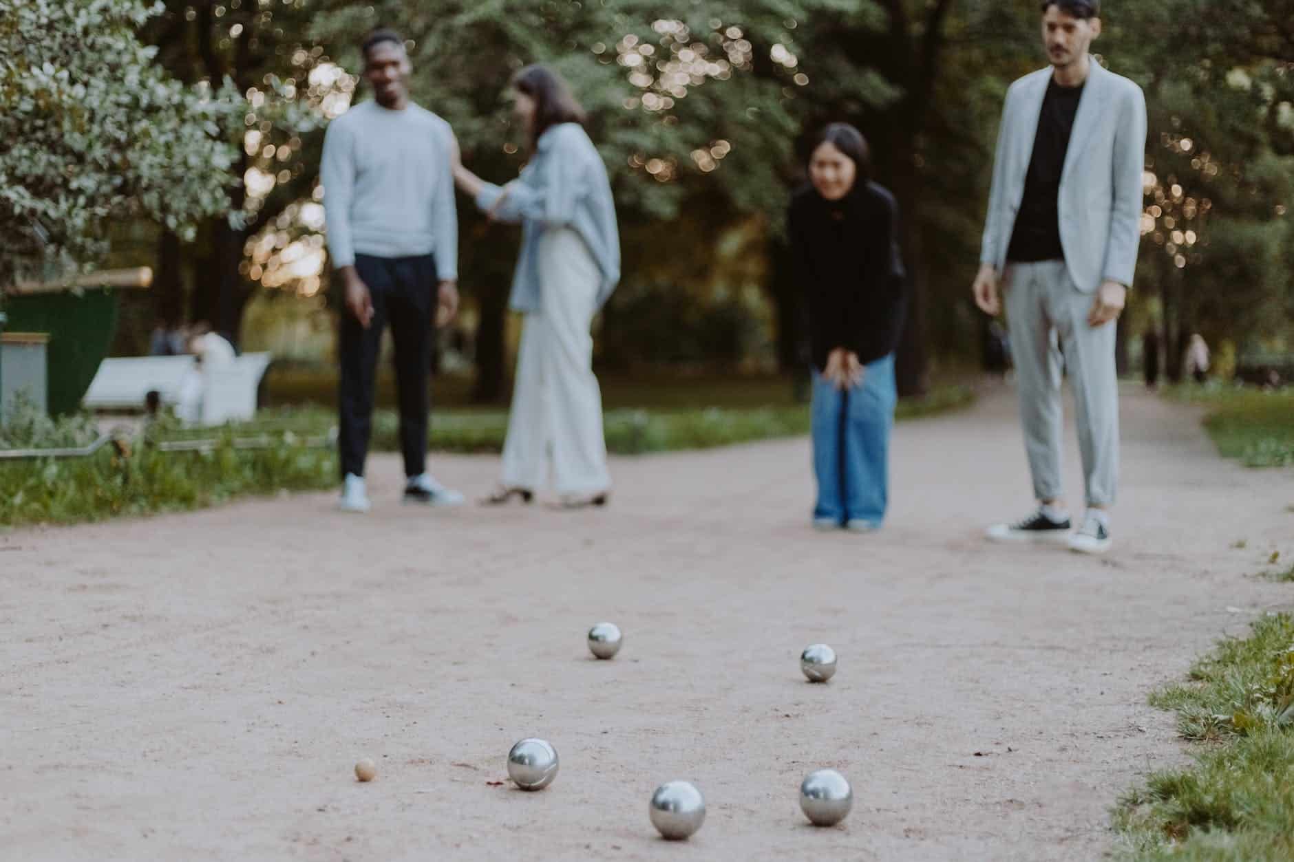 a man and a woman playing balls on sand