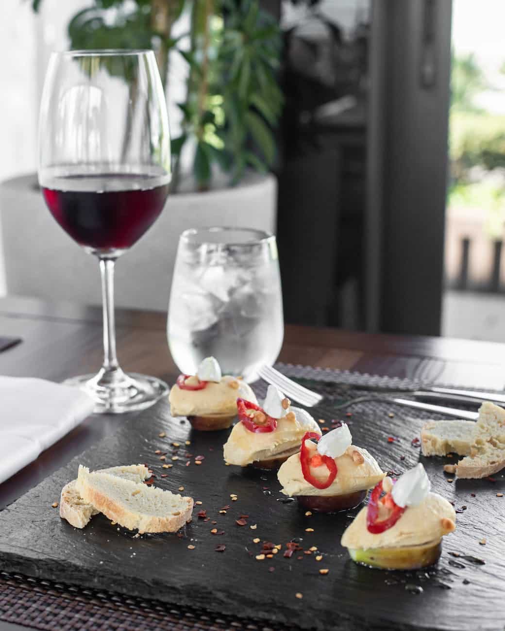 delicious food served on table with glass of red wine