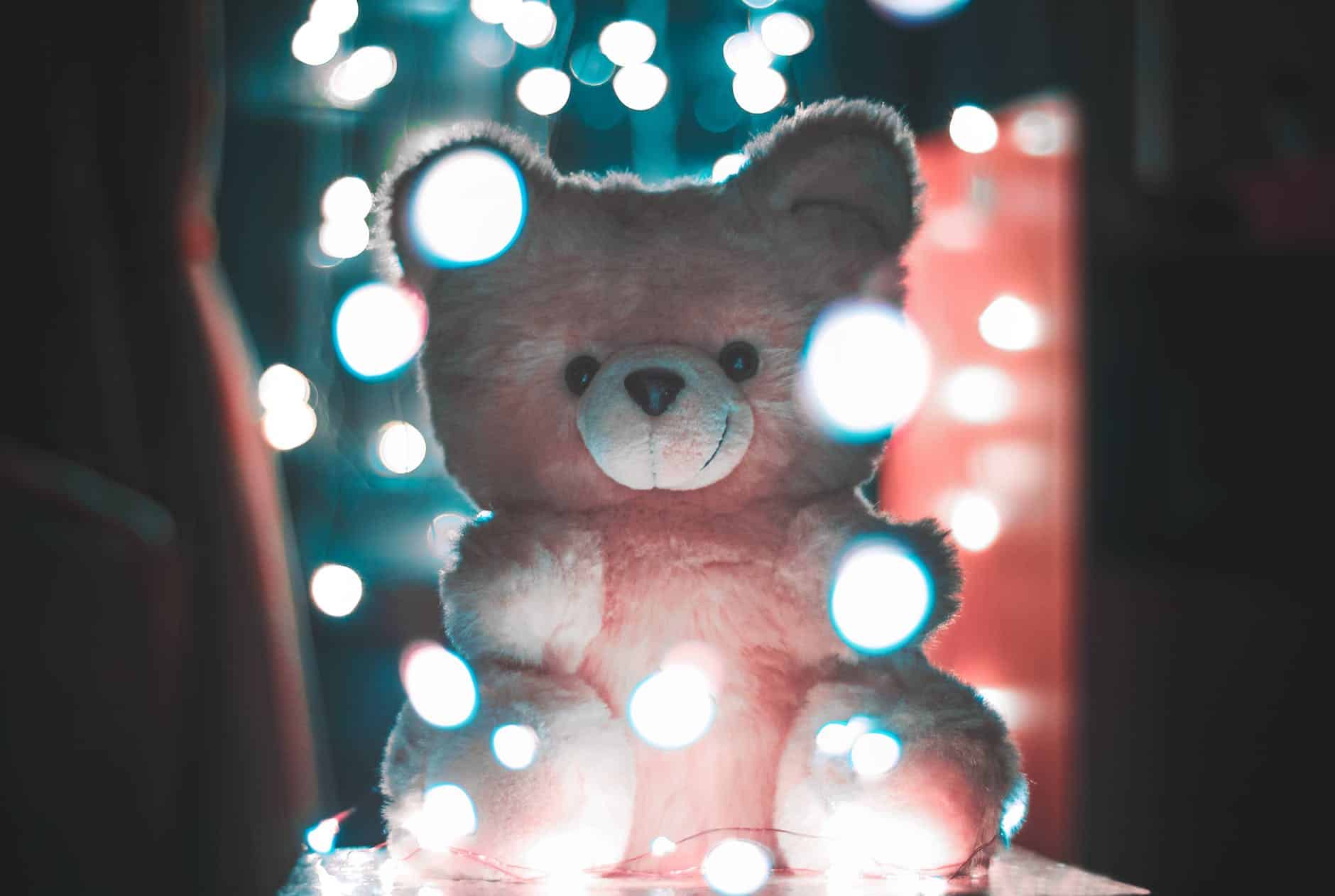 bokeh photography of pink bear plush toy