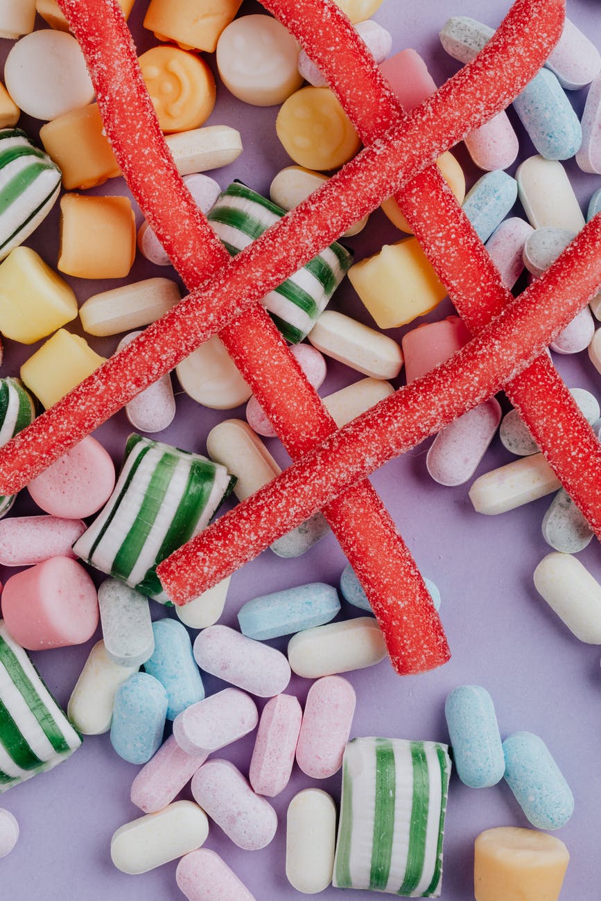 multicolored candies on lilac surface