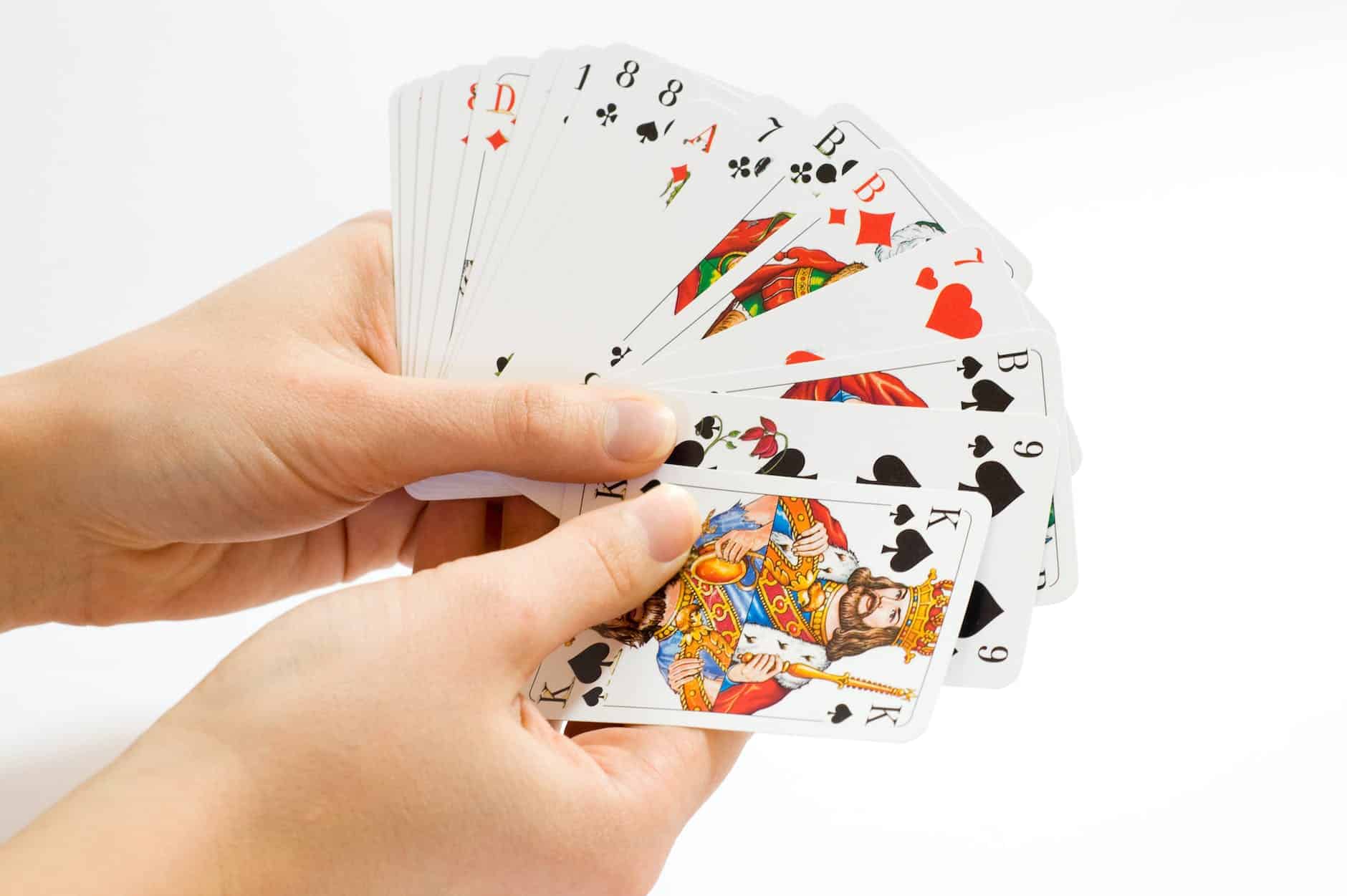 person holding playing cards