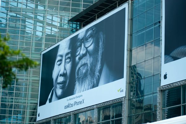 man beside woman billboard