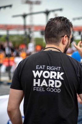 person wearing eat right work hard feel good printed shirt
