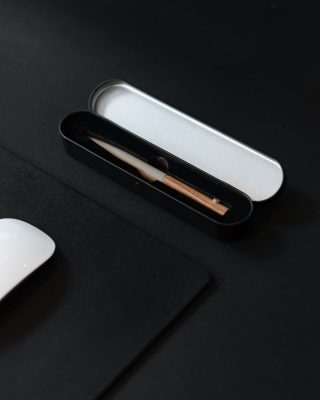 small black case for pencil on black surface