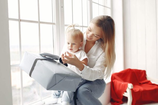 mother and daughter holding a gift